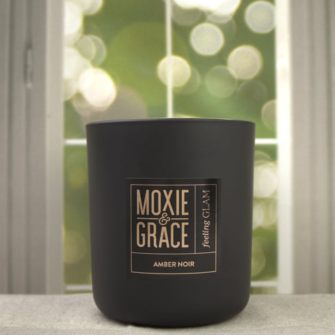 Amber Noir 12oz Candle in Black by Moxie & Grace — a dark, sultry blend of amber, black oud, vetiver, patchouli, and smoked musk