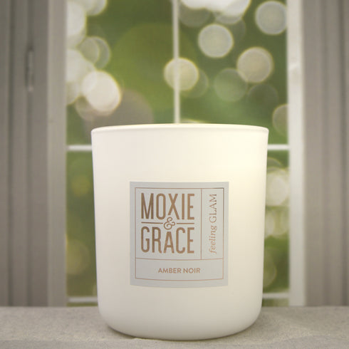 Amber Noir 12oz Candle in White by Moxie & Grace — a dark, sultry blend of amber, black oud, vetiver, patchouli, and smoked musk