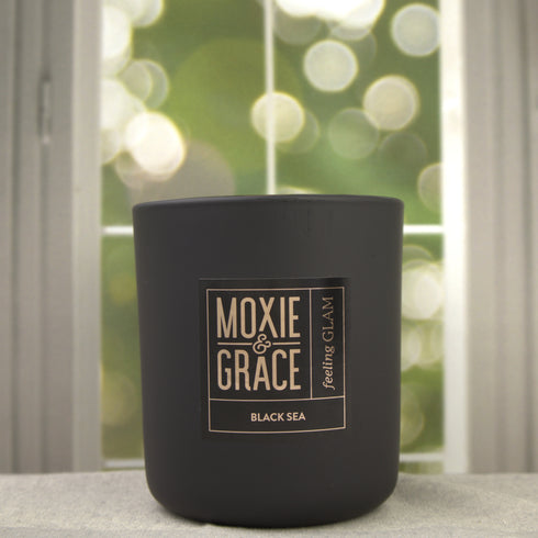 Sweet Tobacco 12oz Candle in Black by Moxie & Grace — a rich, warm blend of tobacco, vanilla, honey, amber, and dark musk