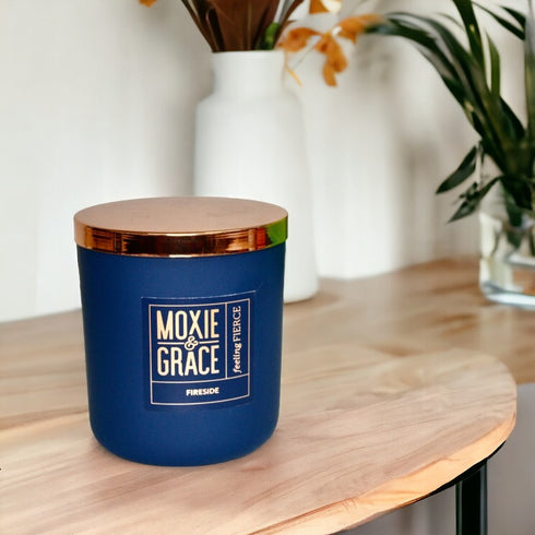 Fireside 12oz Candle in Navy by Moxie & Grace — a warm, smoky blend of cedarwood, sandalwood, birch, and smoked amber