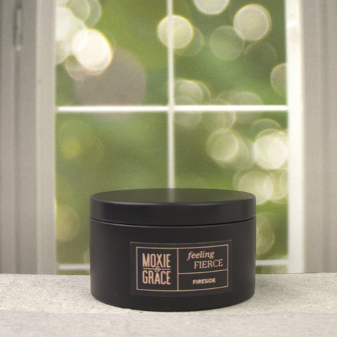 Fireside 5oz Candle in Black by Moxie & Grace — a warm, smoky blend of cedarwood, sandalwood, birch, and smoked amber