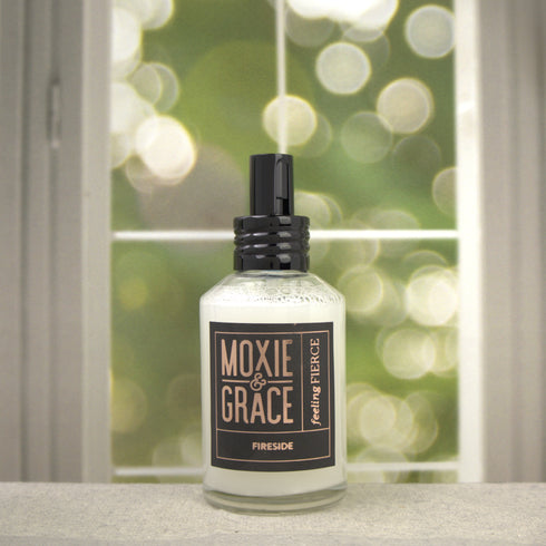 Fireside Room Spray 4oz bottle by Moxie & Grace — warm smoke, clove, amber, sandalwood, and patchouli fragrance, non-toxic and USA-made