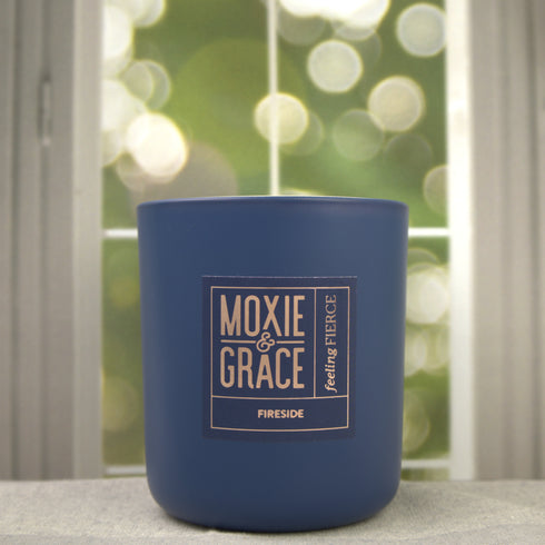 Fireside 12oz Candle in Navy by Moxie & Grace — a warm, smoky blend of cedarwood, sandalwood, birch, and smoked amber