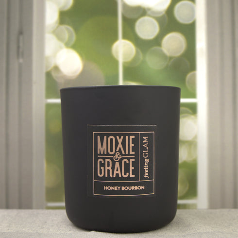 Honey Bourbon 12oz Candle in Black by Moxie & Grace — a rich, warming blend of honey, bourbon, vanilla, amber, and oak