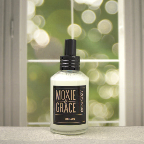 Library 4oz Room Spray by Moxie & Grace — a sophisticated blend of teakwood, cedar, leather, sandalwood, and dark musk
