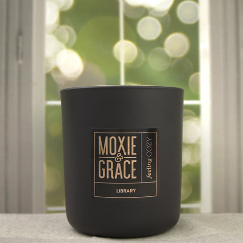 Library 12oz Candle in Black by Moxie & Grace — a sophisticated blend of teakwood, cedar, leather, sandalwood, and dark musk