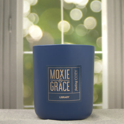 Library 12oz Candle in Navy by Moxie & Grace — a sophisticated blend of teakwood, cedar, leather, sandalwood, and dark musk
