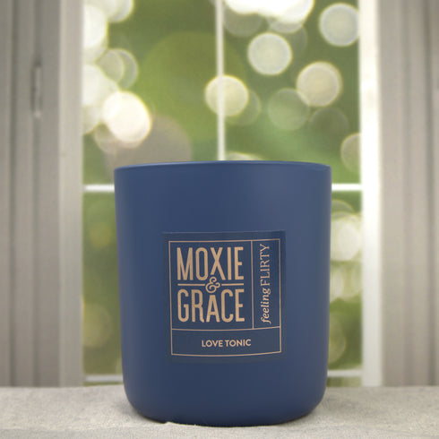 Love Tonic 12oz Candle in Navy by Moxie & Grace — a sweet fruity-floral blend of apple, peach, cherry blossom, hydrangea, and vanilla