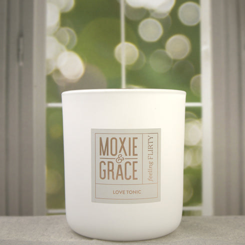 Love Tonic 12oz Candle in White by Moxie & Grace — a sweet fruity-floral blend of apple, peach, cherry blossom, hydrangea, and vanilla
