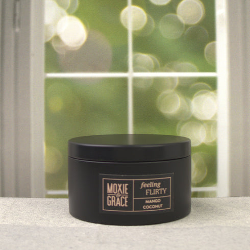 Mango Coconut 5oz Candle in Black by Moxie & Grace — a tropical blend of ripe mango, coconut milk, vanilla, and warm musk