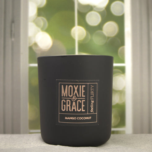 Mango Coconut 12oz Candle in Black by Moxie & Grace — a tropical blend of ripe mango, coconut milk, vanilla, and warm musk