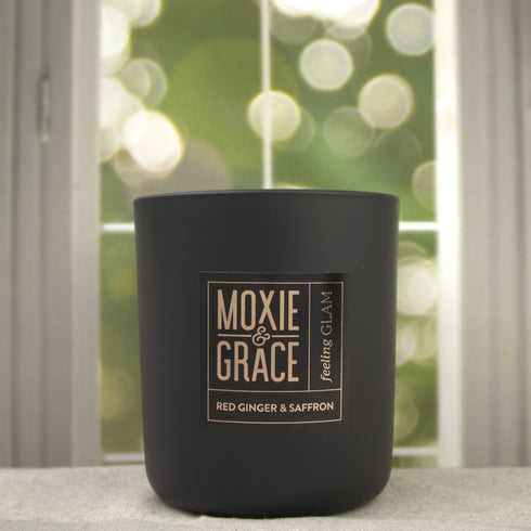 Red Ginger & Saffron 12oz Candle in Black by Moxie & Grace — a vibrant blend of ginger, saffron, lemon, amber, patchouli, and cedarwood