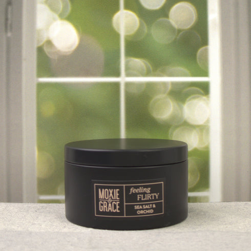 Sea Salt & Orchid 5oz Candle in Black by Moxie & Grace — a coastal floral blend of sea salt, freesia, orchid, tonka bean, and amber