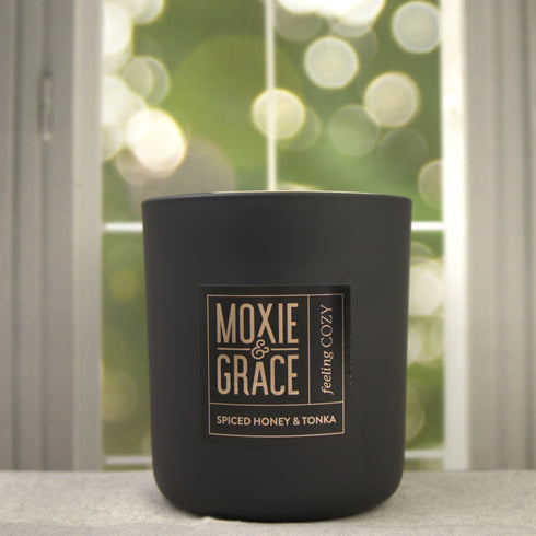 Spiced Honey & Tonka 12oz Candle in Black by Moxie & Grace — a warm blend of honey, tonka bean, cinnamon, clove, and vanilla