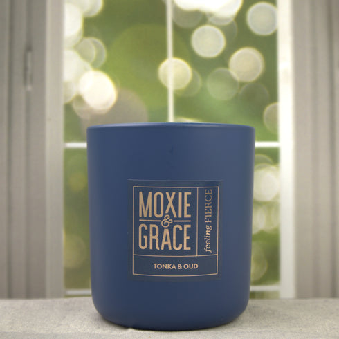 Tonka & Oud 12oz Candle in Navy by Moxie & Grace — a luxurious blend of oud, tonka bean, sandalwood, amber, and dark musk