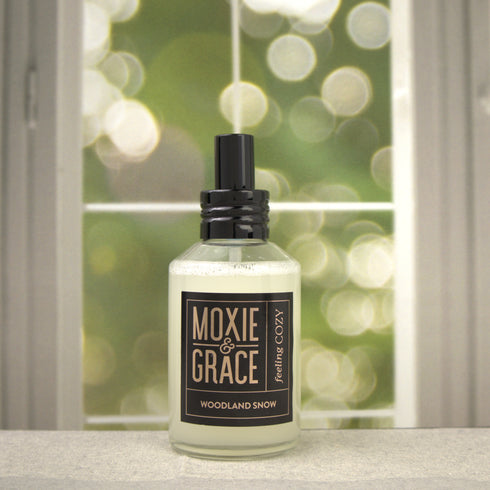 Woodland Snow 4oz Room Spray by Moxie & Grace — a crisp, wintry blend of pine, cedarwood, eucalyptus, and fresh snow